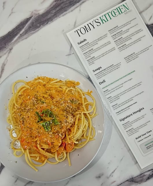 Pasta beside a Tonys Kitchen menu photographed for the official social account